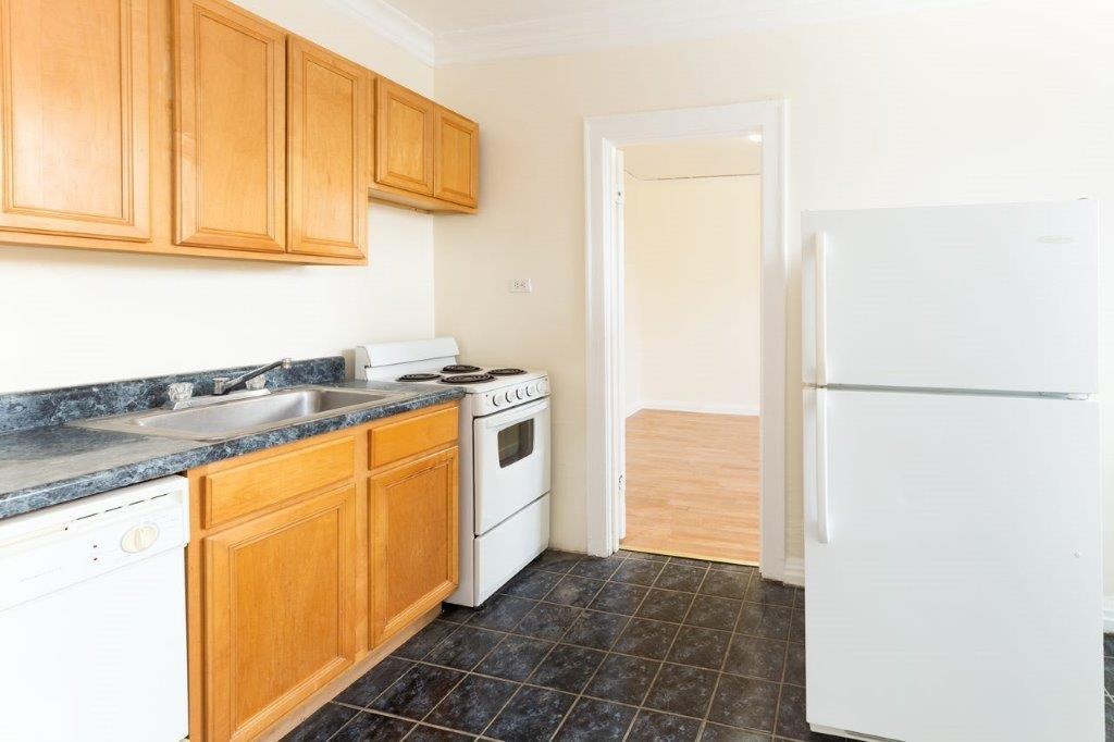 Kitchen with wooden cabinets and a dishwasher.