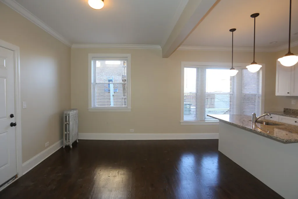 Open concept living space with kitchen and work combo.  Hardwwod floors and pendant lighting are featured.