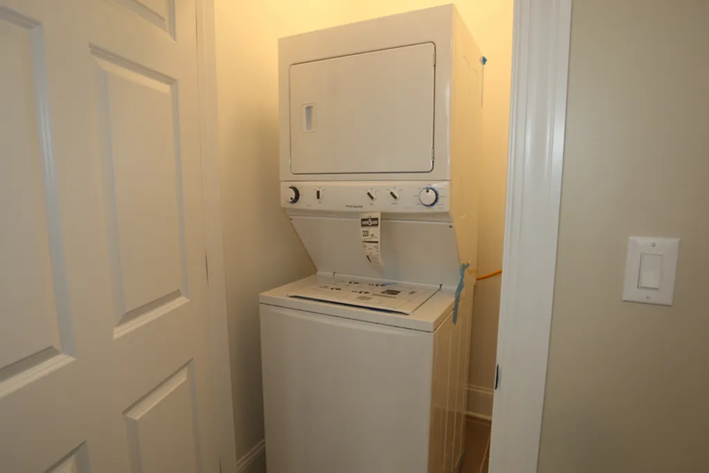 A white stackable washer / dryer.