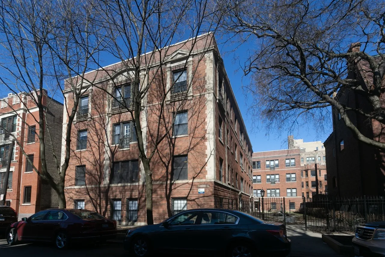 Exterior of 1360-64 East 52nd Street a handsome twenty two unit 3.5 story red brick courtyard building on a tree lined street in Hyde Park.