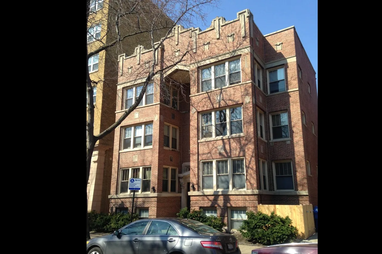 Exterior of 5326 South Harper a vintage thirteen unit three story red brick exterior on a tree lined street in Hyde Park.