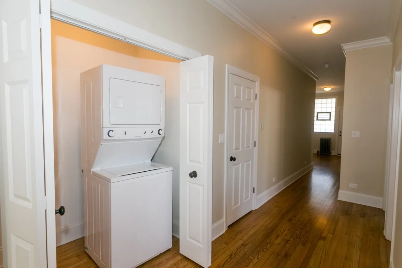 In unit stackable washer and dryer inside a large closet.