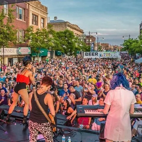 Midsommarfest in Andersonville.  A festival with hundreds of people in the street listening to a live band.