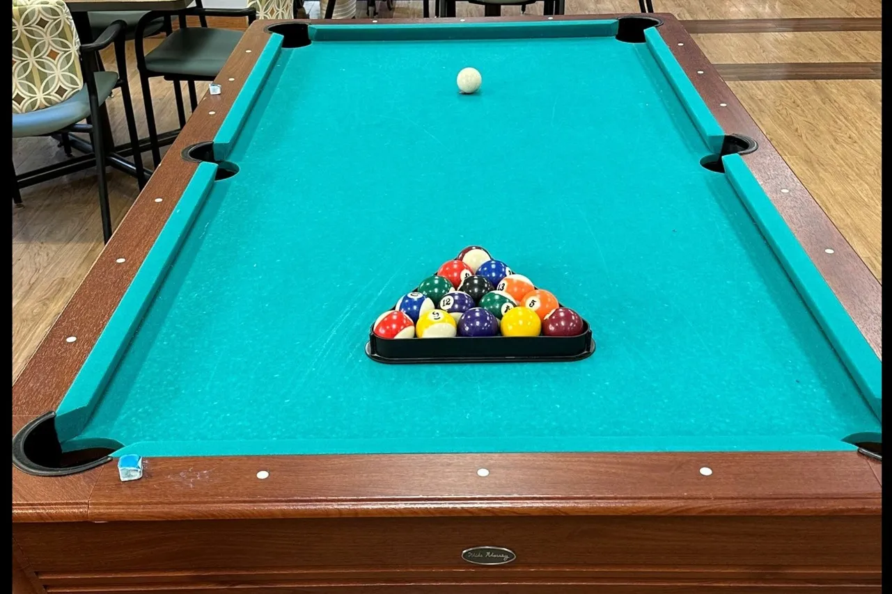 Billiards table with racked balls.