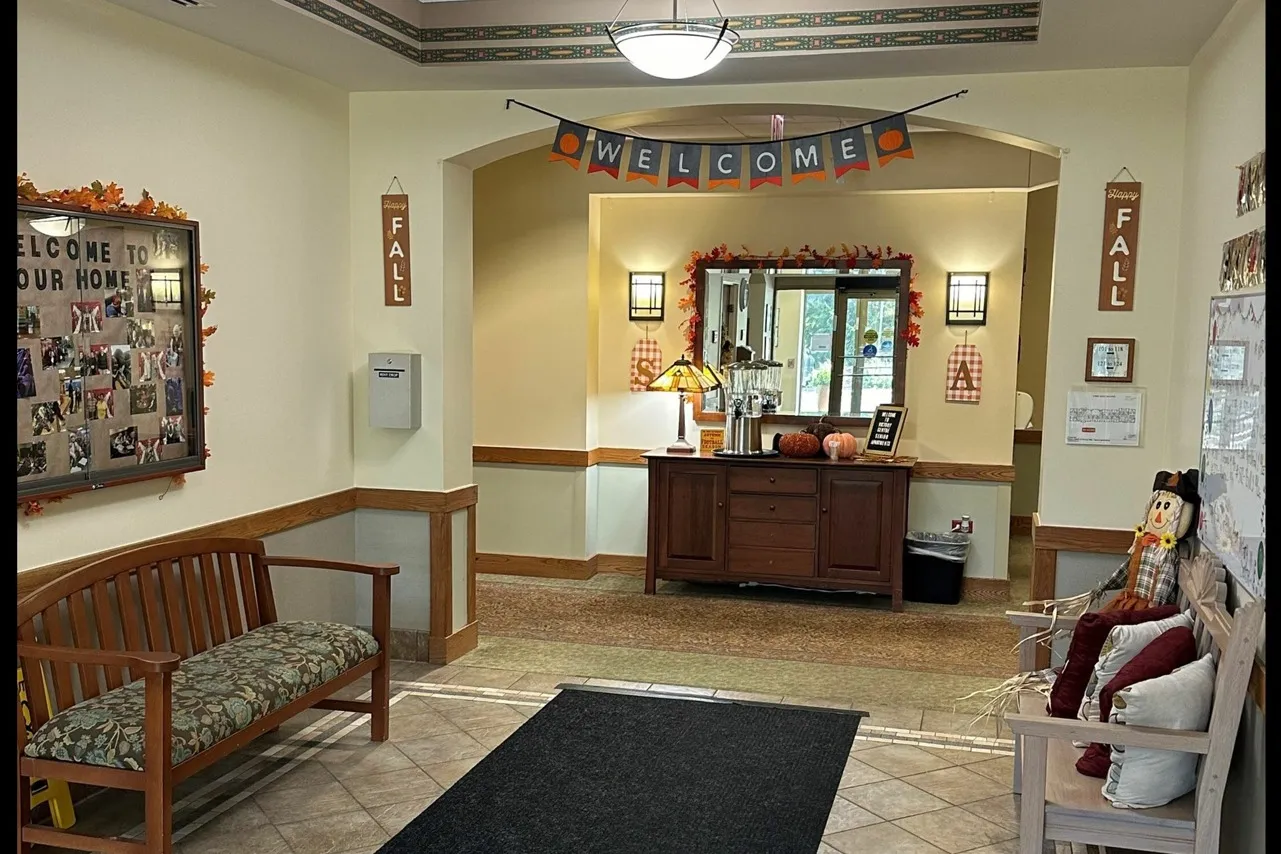 Furnished welcoming lobby with a streamer, chairs and elegant lighting.