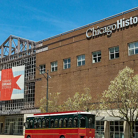 Chicago History Museum exterior with brown brick and a bus in front.