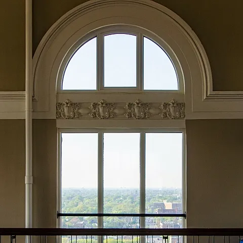 A round top window on the 15th floor of the Nichols Tower looking outside.