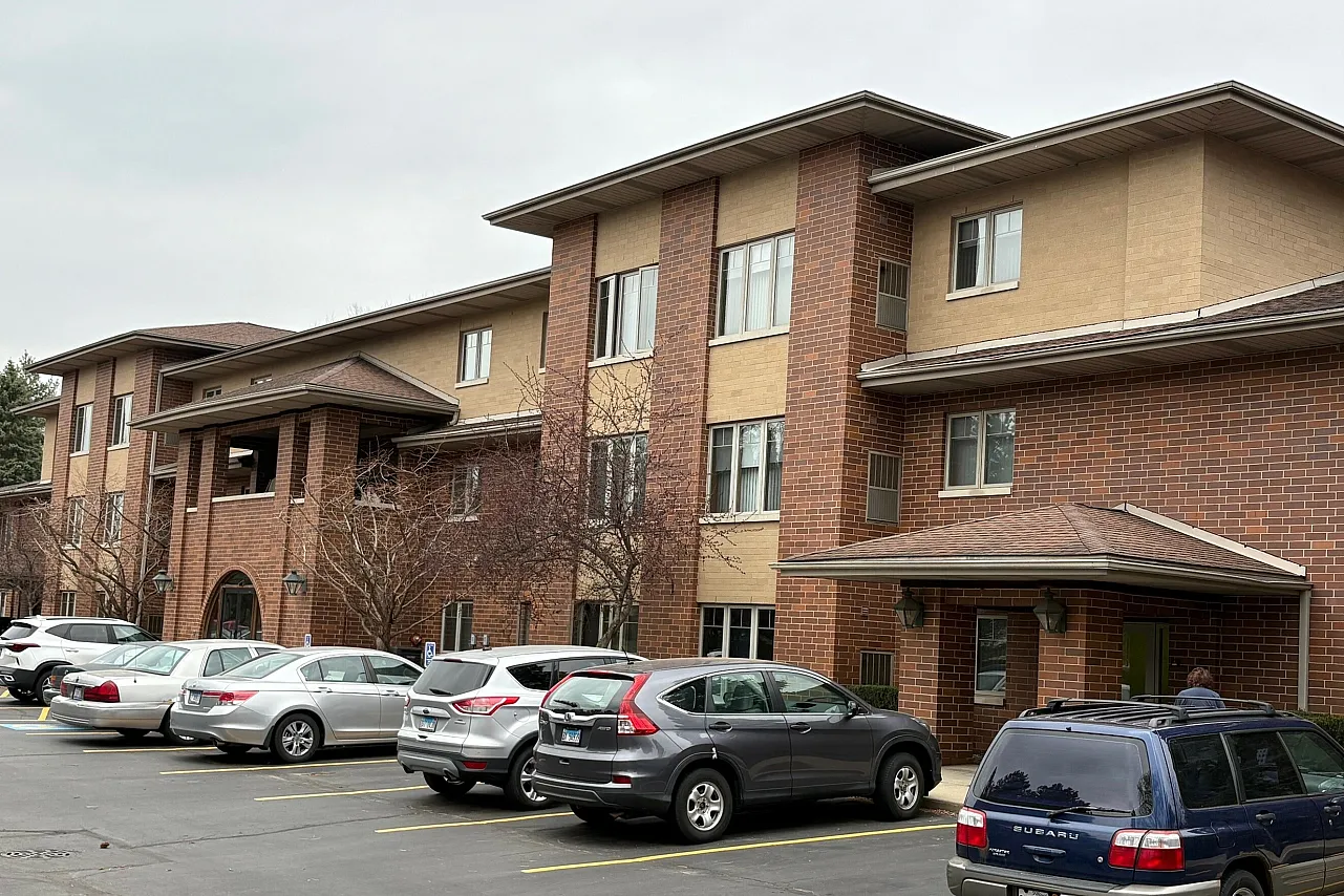 Exterior of Tiffany Road Apartments a thirty eight unit income restricted senior building with red brick exterior and mature landscaping.