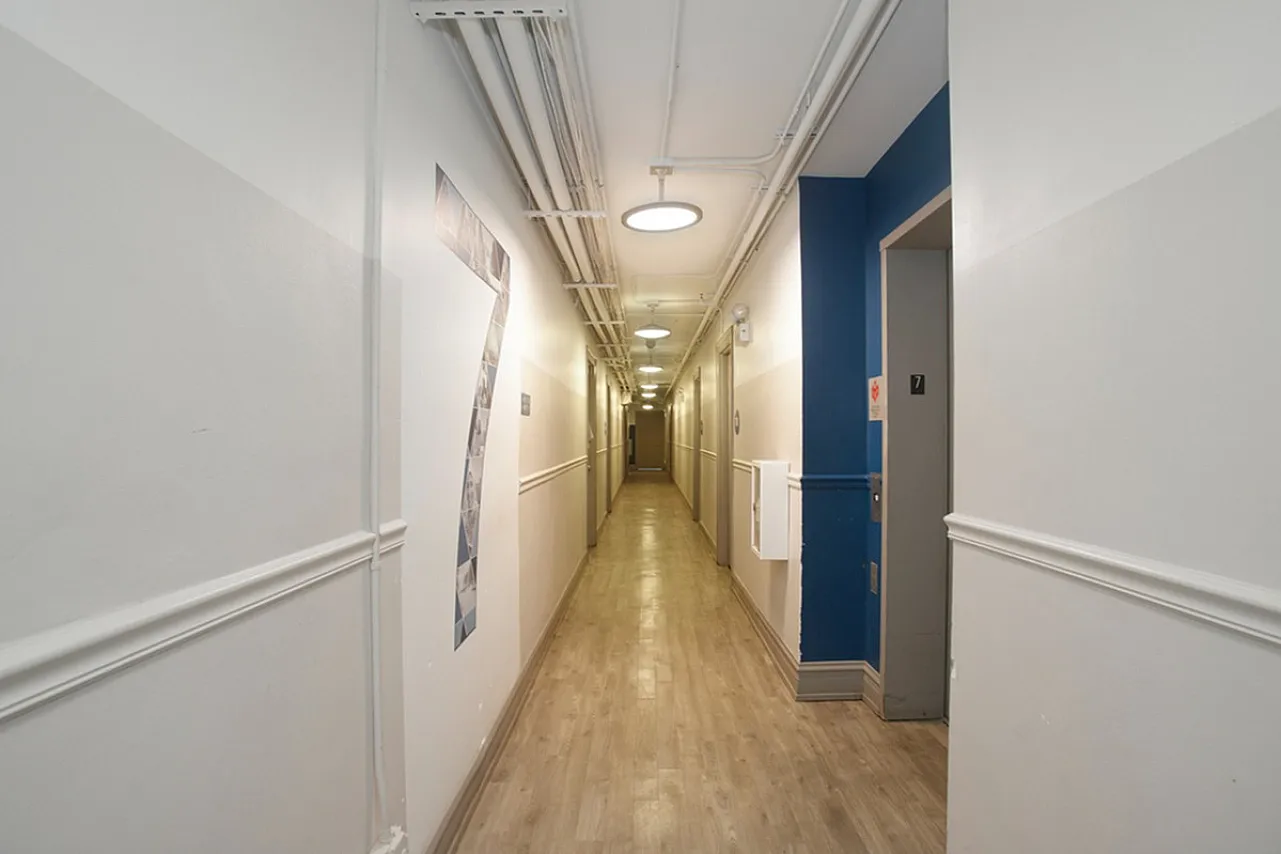 Building hallway gray with accent blue wall and large 7 on the wall
