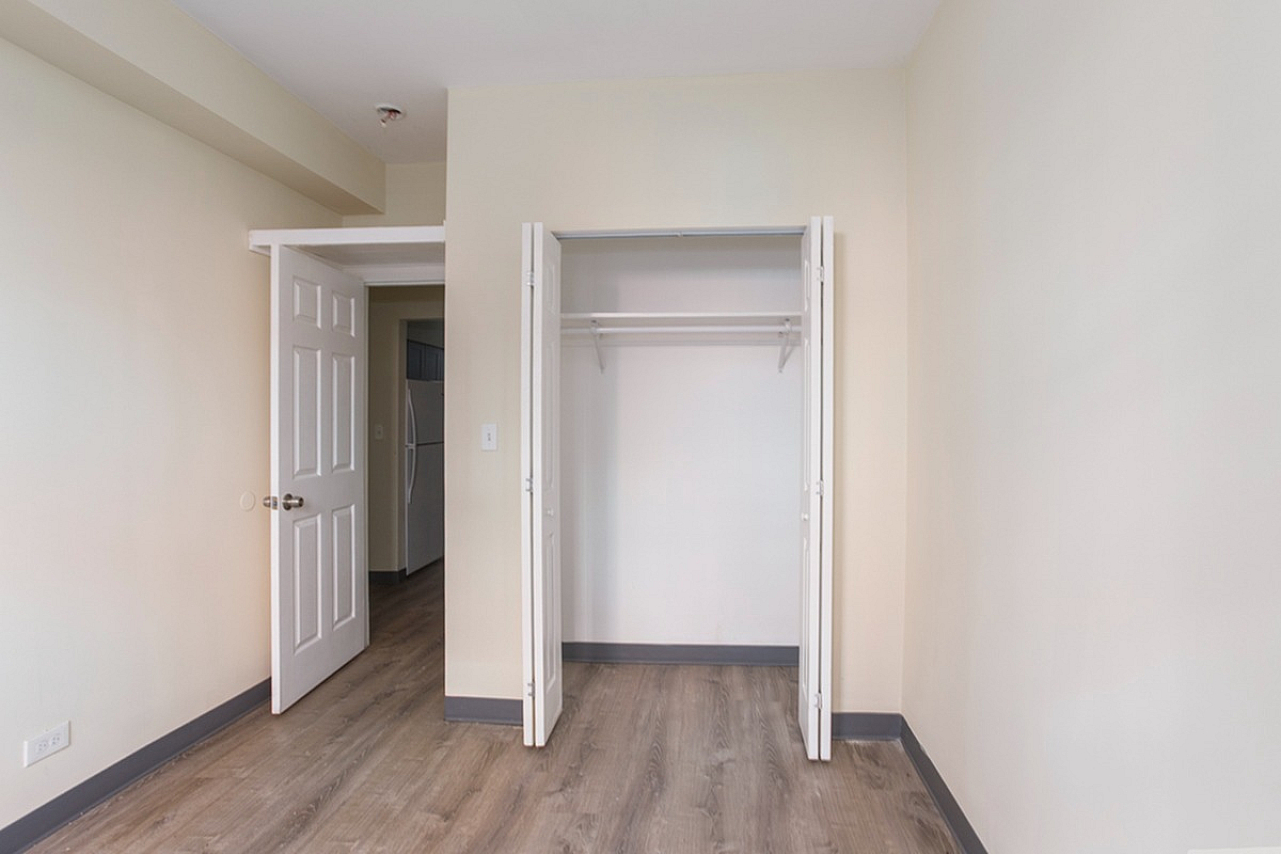 Bedroom with large closet and vinyl plank flooring