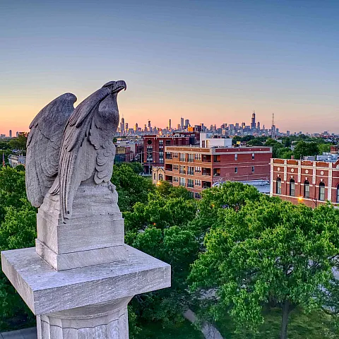 Stone eagle on top of monument in Logan Square Chicago