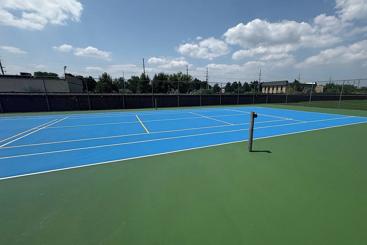 Blue Tennis and pickle ball court with green out of boundsb