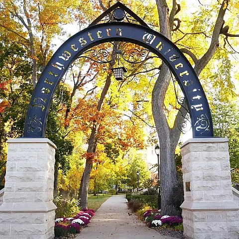 Northwestern university arch leading into the campus with leaves changing colors