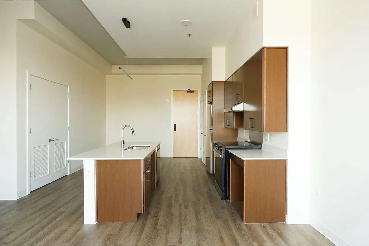 Open concept kitchen with brown cabinets and Vinyl Flloring