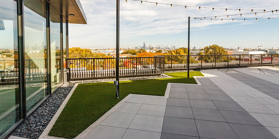Roof top deck looking at chicago skyline next to glass sliding doors
