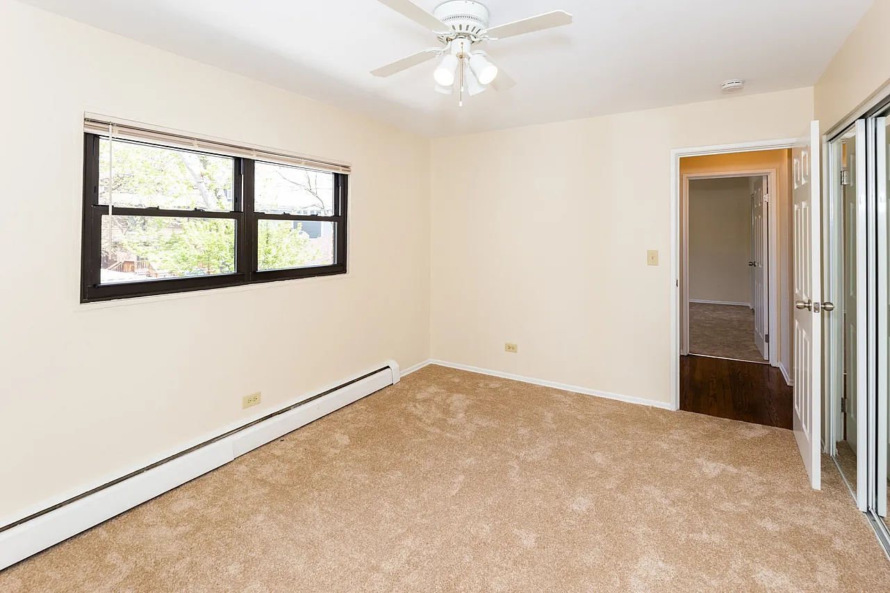 Bedroom with ceiling fan and carpet on the floor