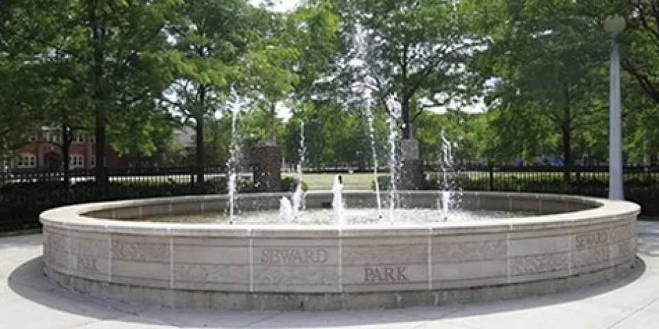 Seward Park fountain with water spraying upward on a summer day.