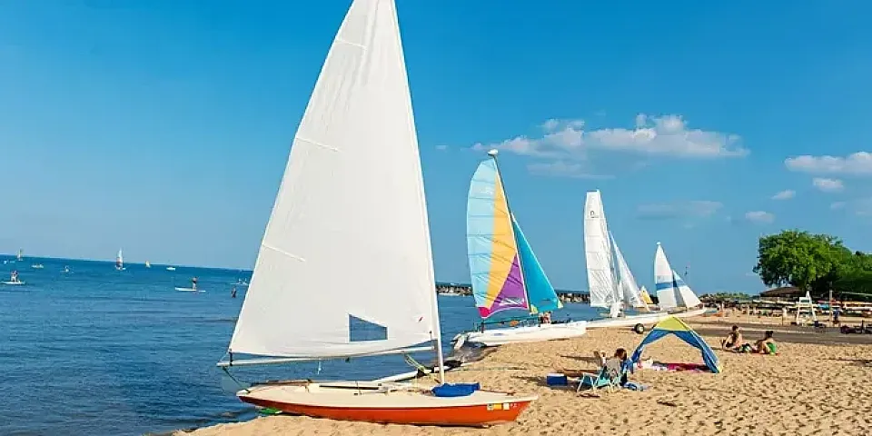 Sailboats on the beach on Lake Michigan in the summer.