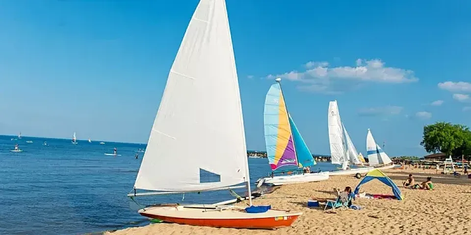 Sailboats on the beach on Lake Michigan in the summer.