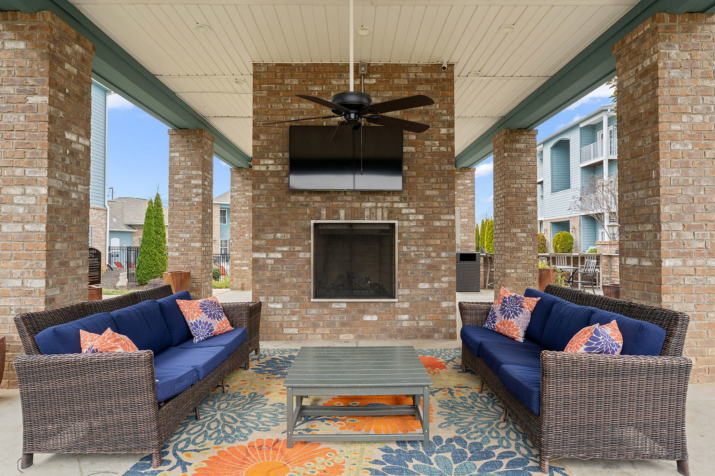 outdoor seating beside the firepit and tv