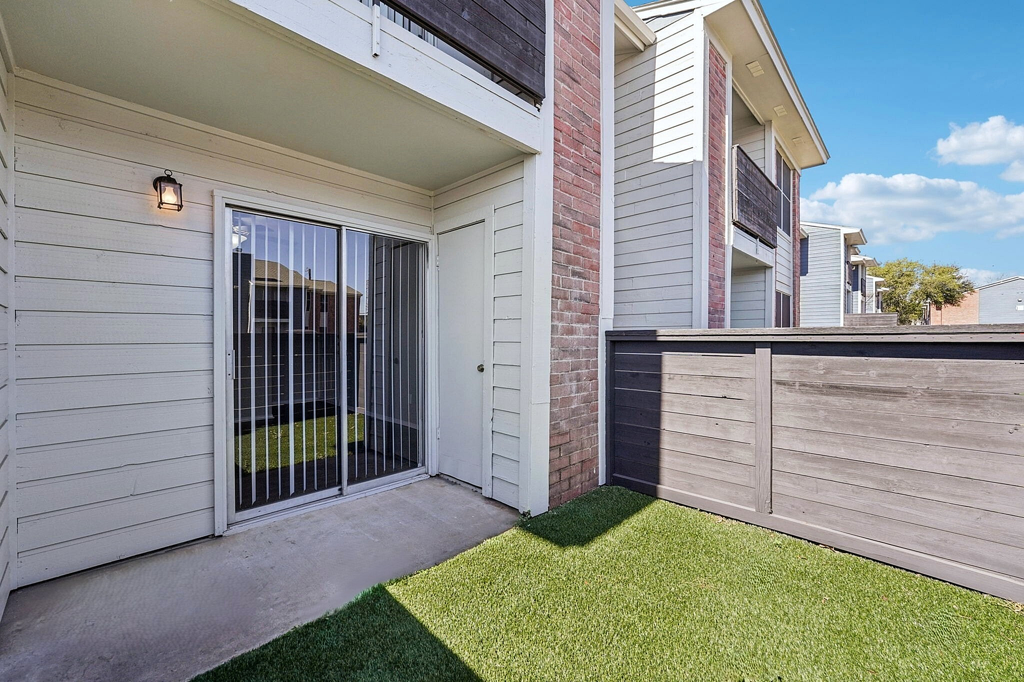 private patio with grass and fence