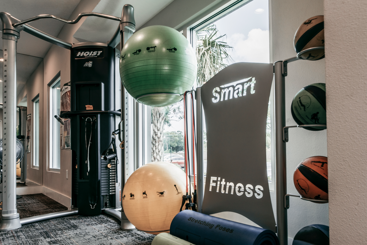 Fitness Center with exercise machines, stability balls, resistance bands, and fitness mats
