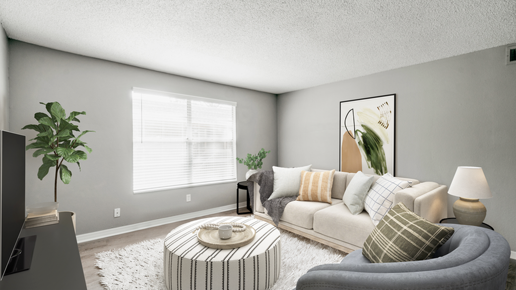 Livingroom tan couch, hardwood floors, rug, gray chair, open window
