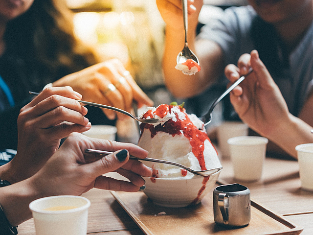 people sharing a delicious dessert