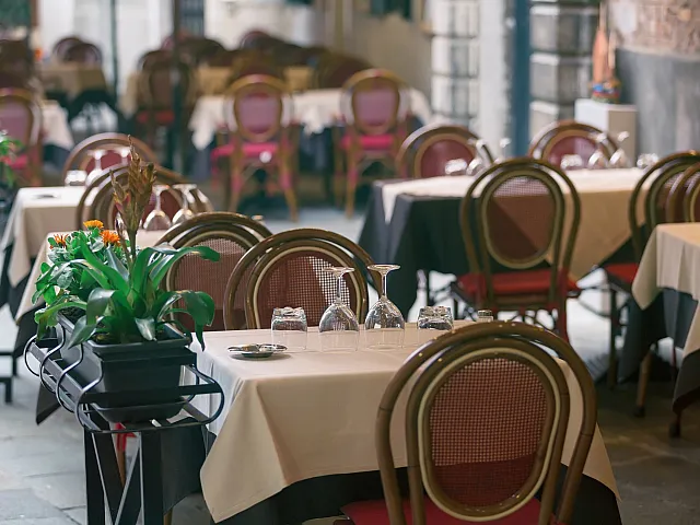 empty modern restaurant with tables, chairs, and decor