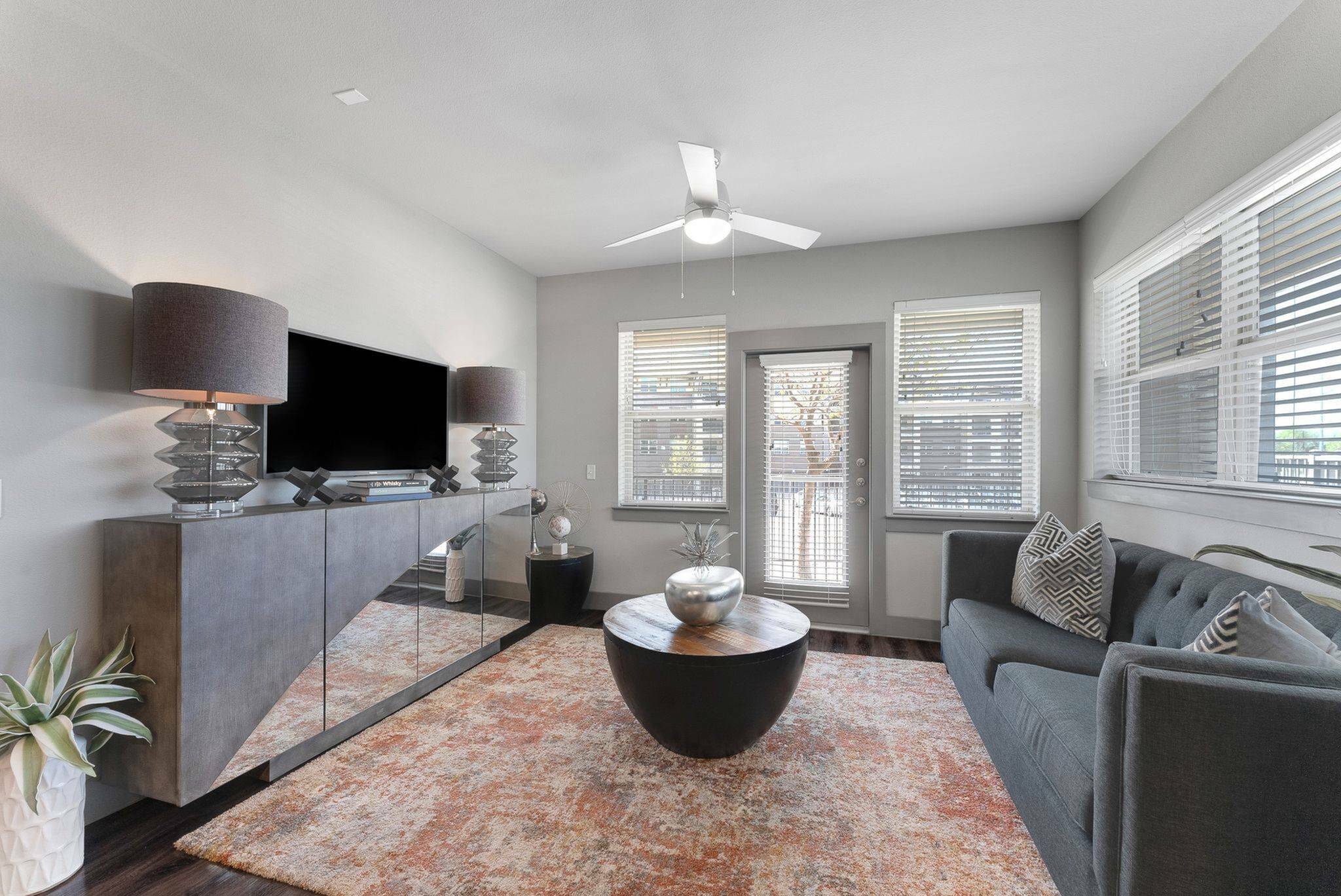 spacious living area with ceiling fan
