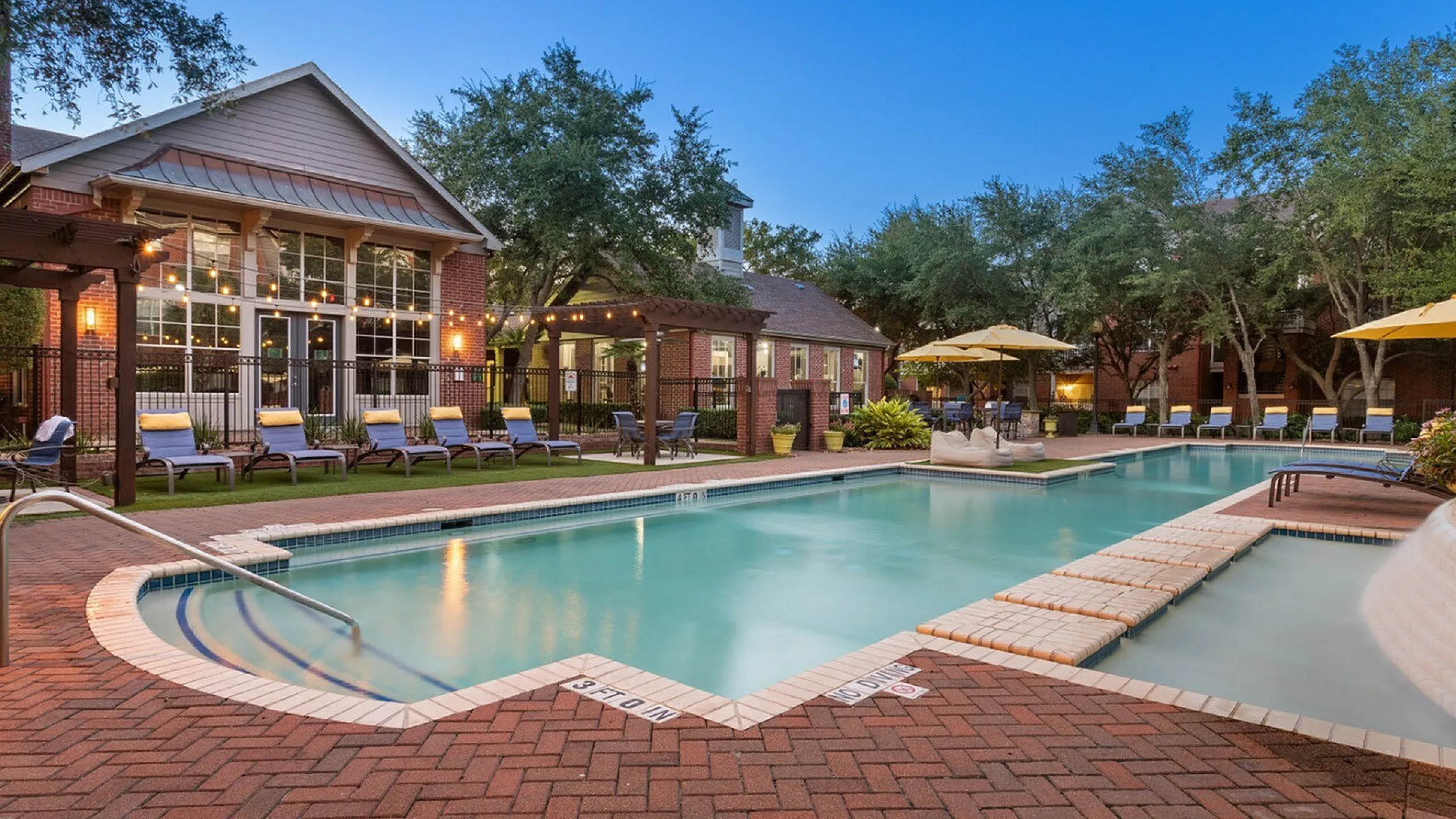 sparkiling pool with lights and seating