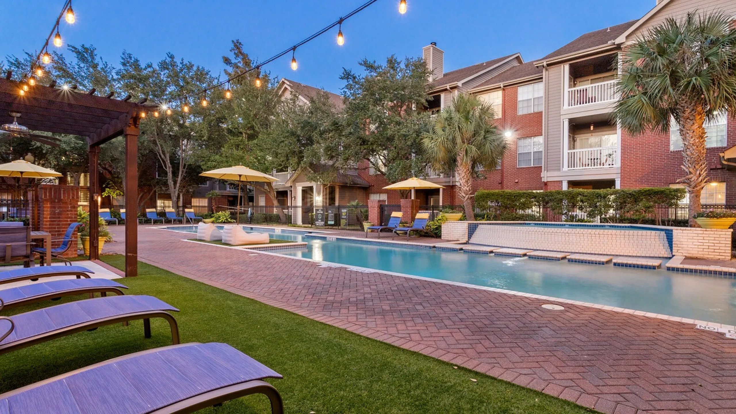 lounge seating beside the pool with fairy lights