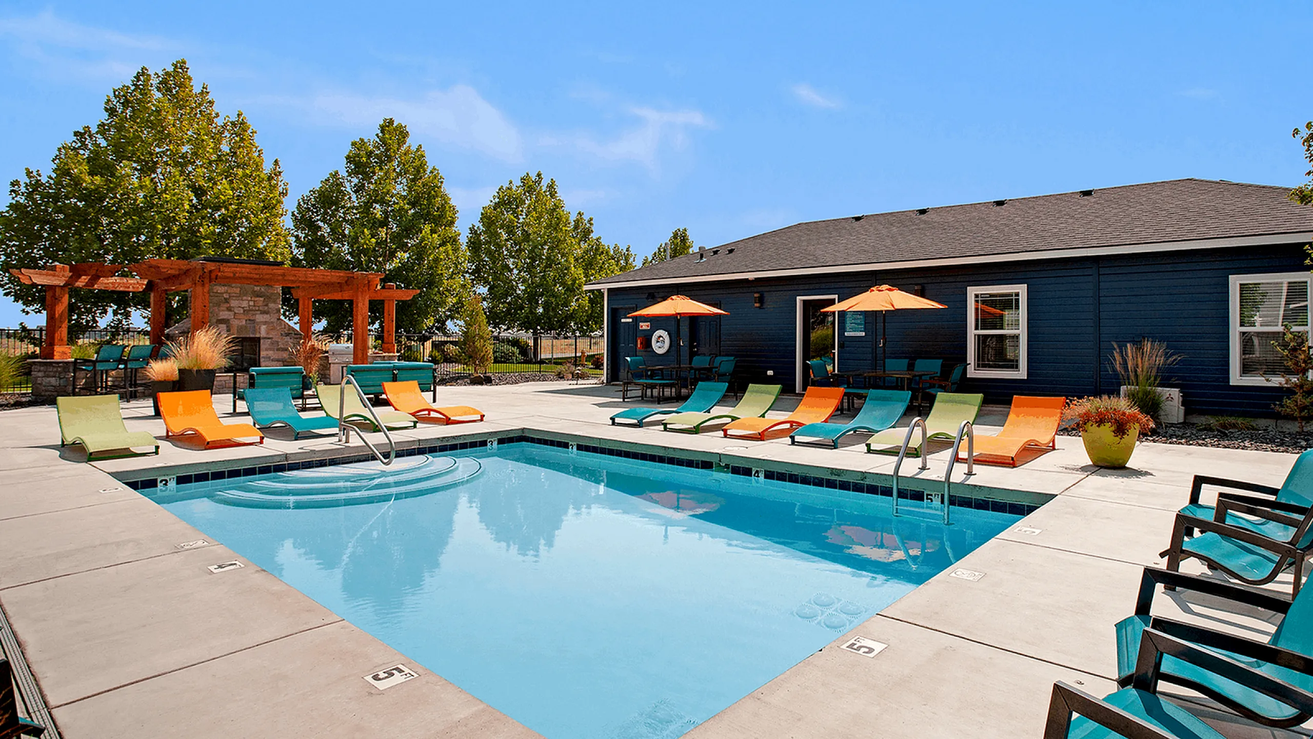 sparkiling pool with colorful lounge seating