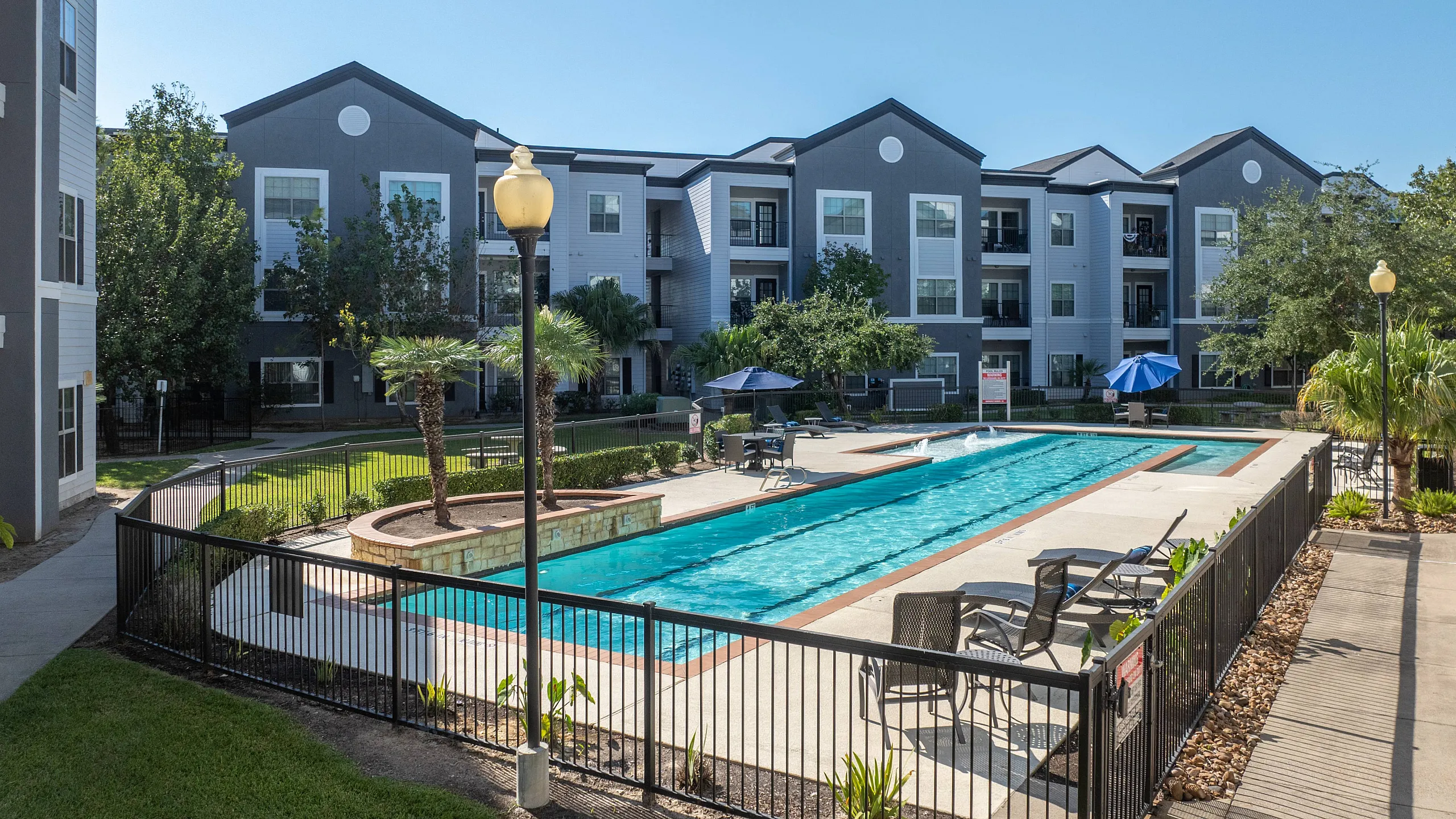 sparkiling pool with fountains and ramp leading down into the water