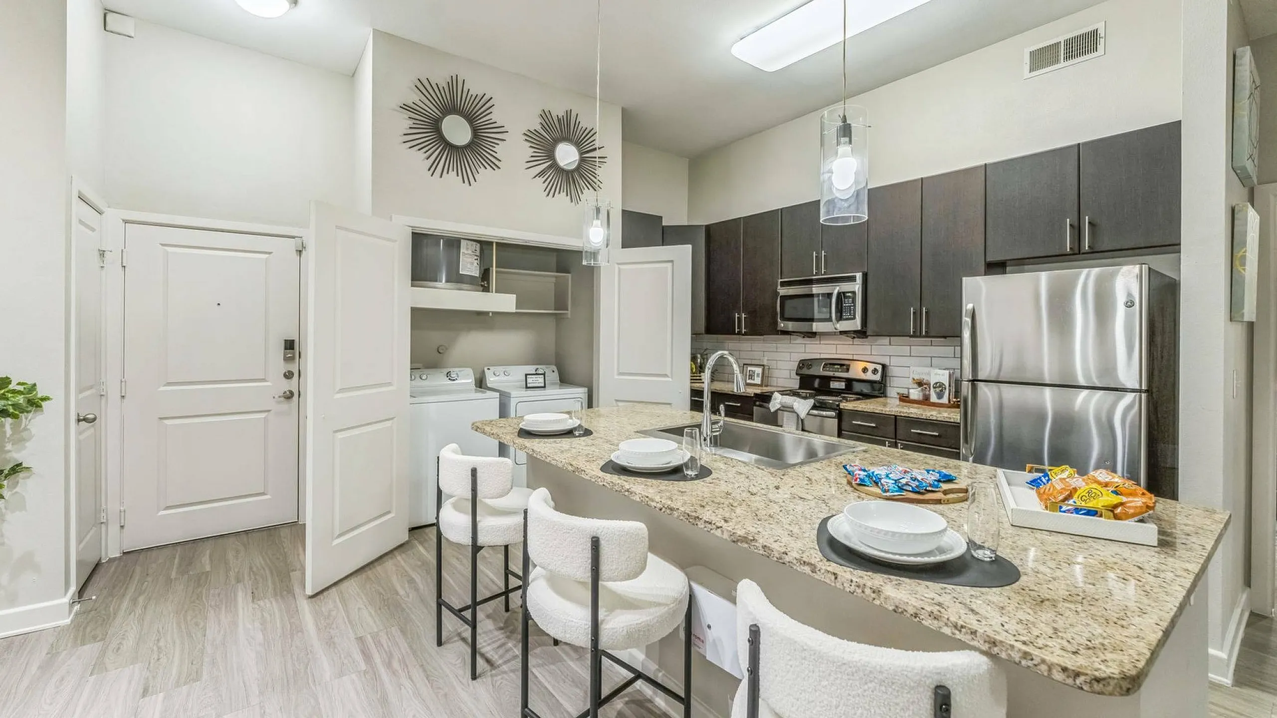 state of the art kitchen with ceiling fan and stainless steel appliances open to the living space