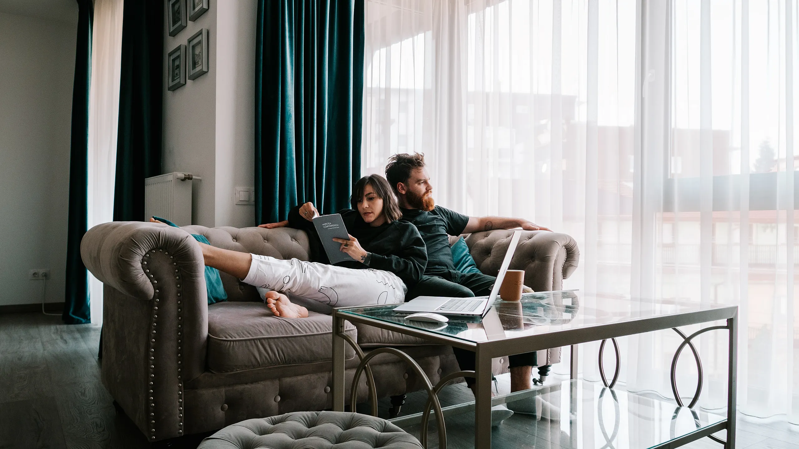 Stock image of a couple enjoying a day on the couch together