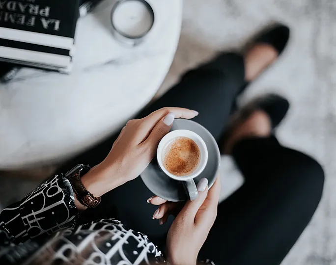stock image of a lady drinking coffee from a mug