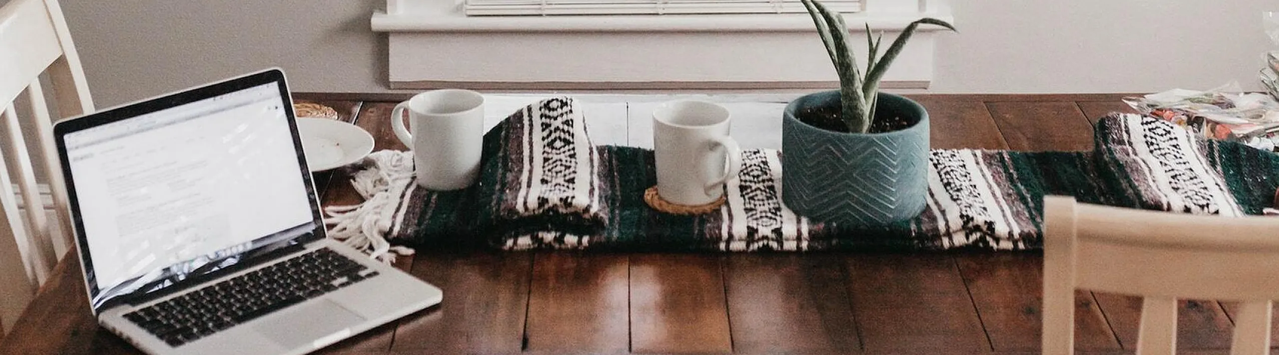 stock of a work space on the kitchen table with coffee