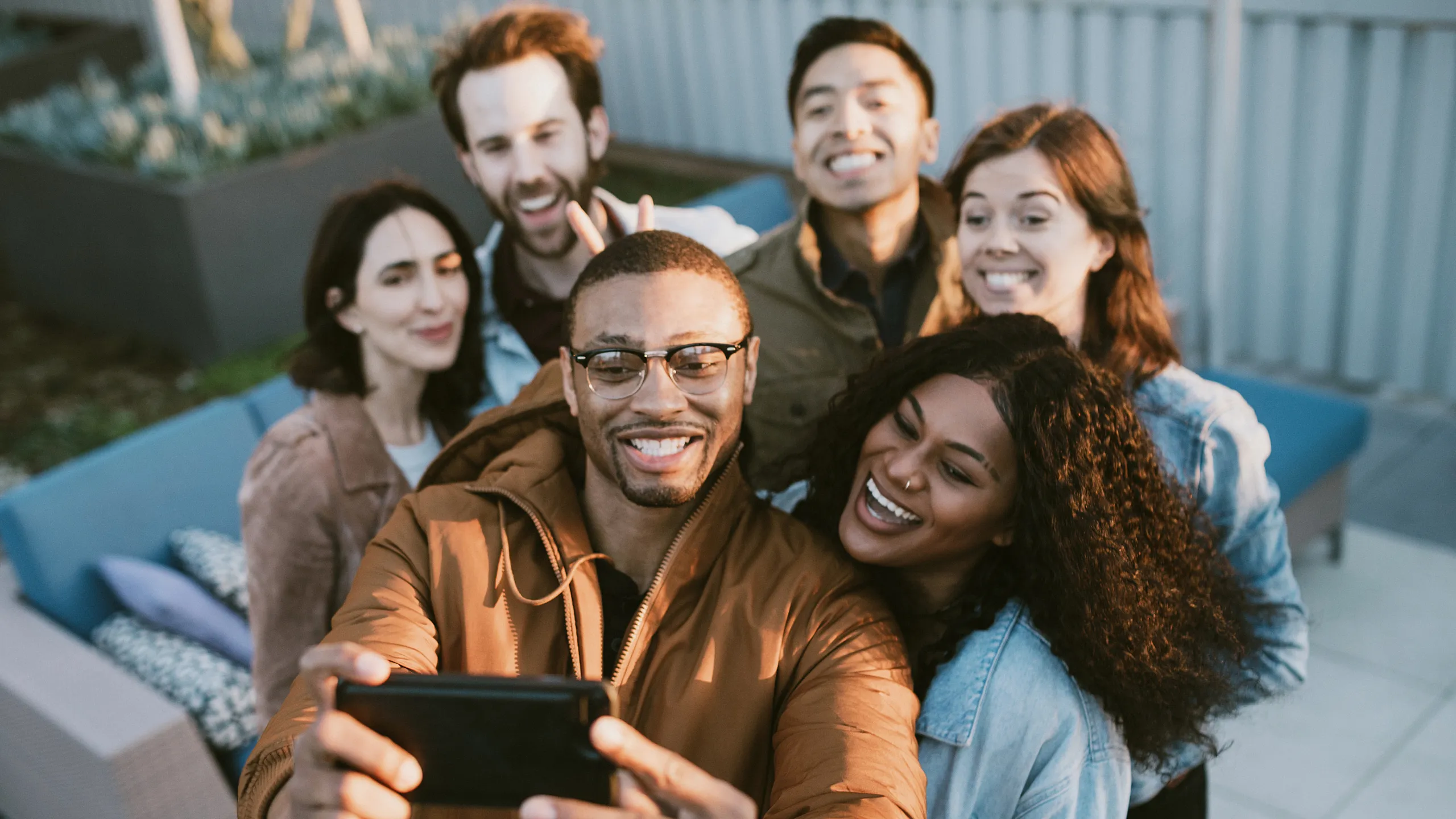stock of a group of friends gathered around for a photoshoot