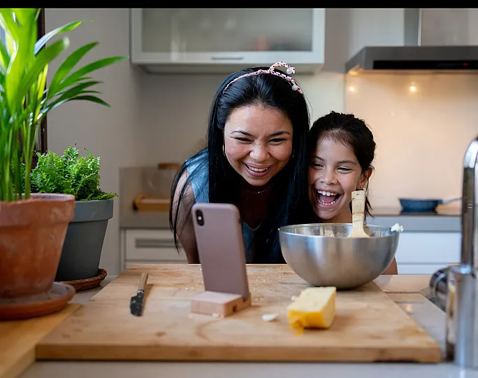 stock of mother and daughter cooking in the kitchen