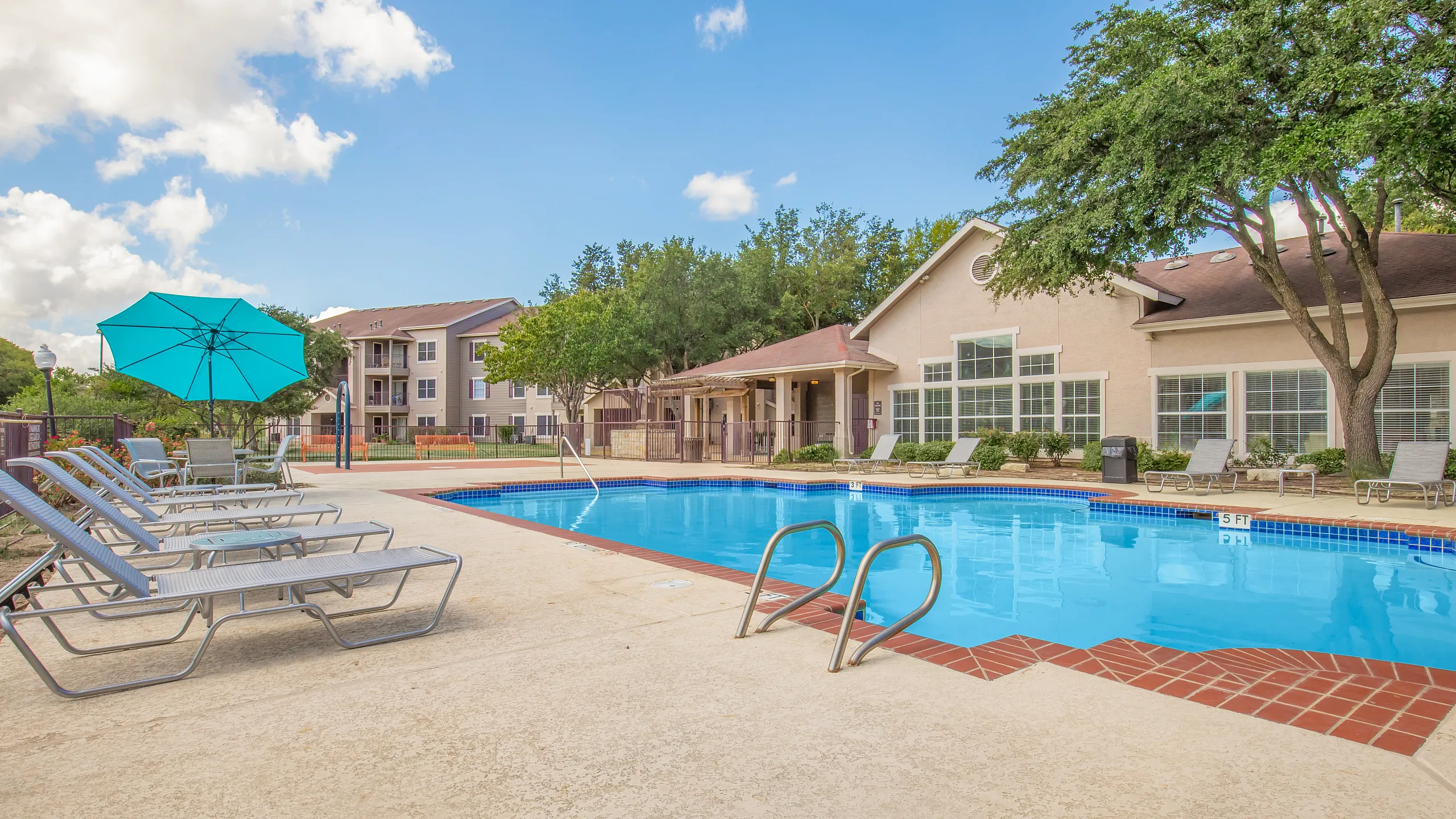 Swimming Pool Surrounded by Greenery and Lounge Chairs in Austin Texas