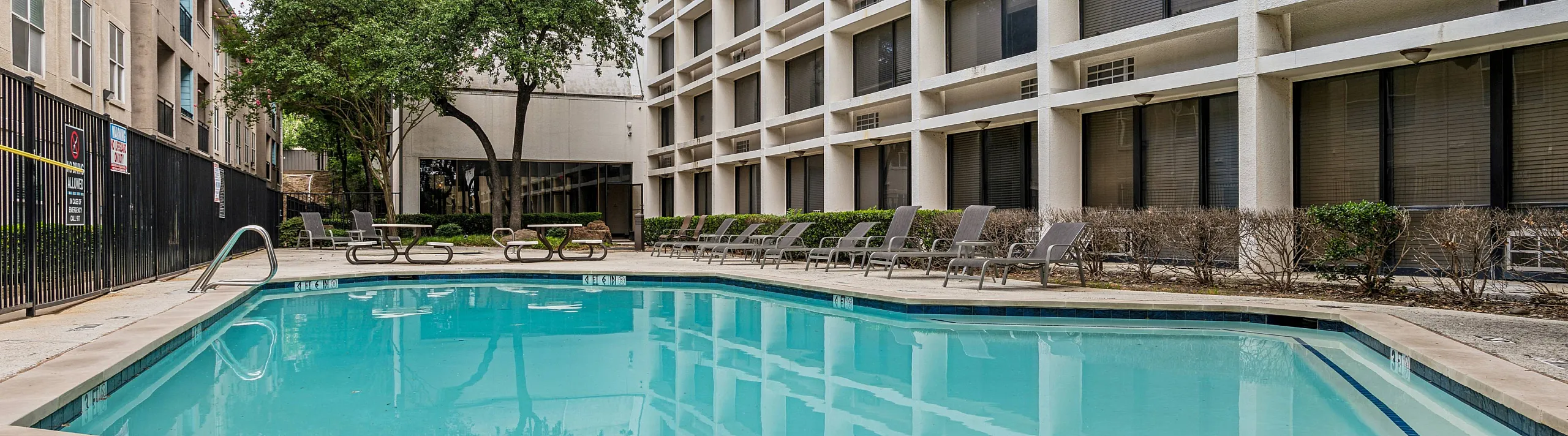 sparkiling pool with resort style lounge seating
