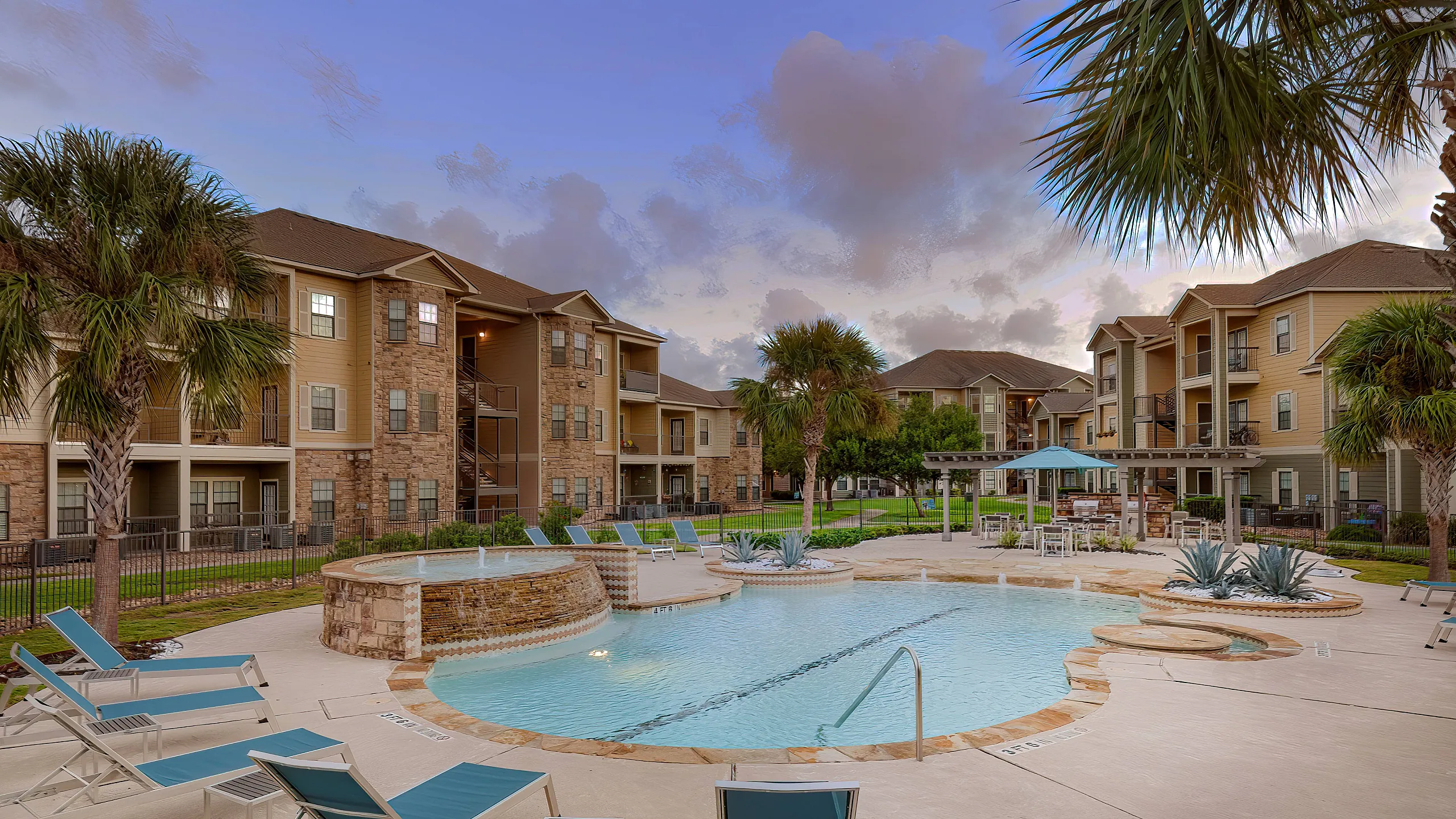sparkiling pool with lounge seating at sunset