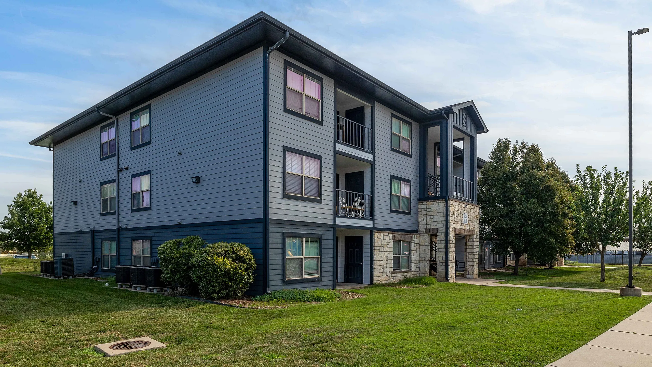 front of apartment buildng with brick and siding
