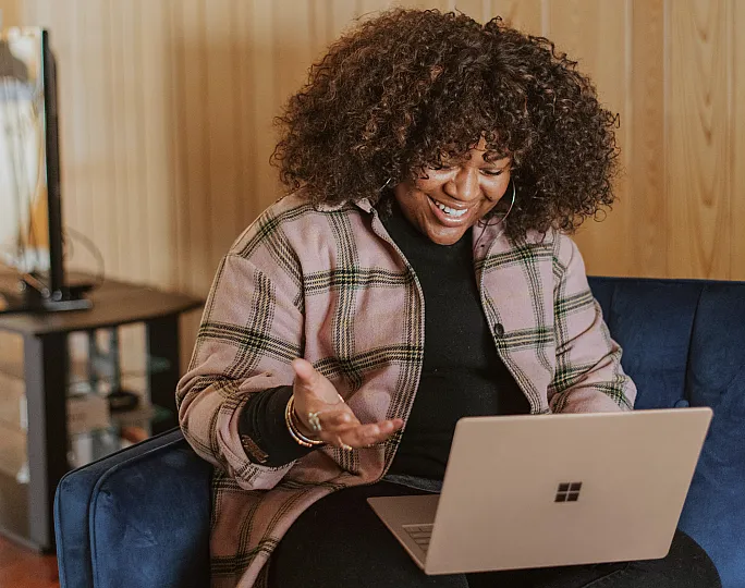 Stock of a woman conversing on her laptop
