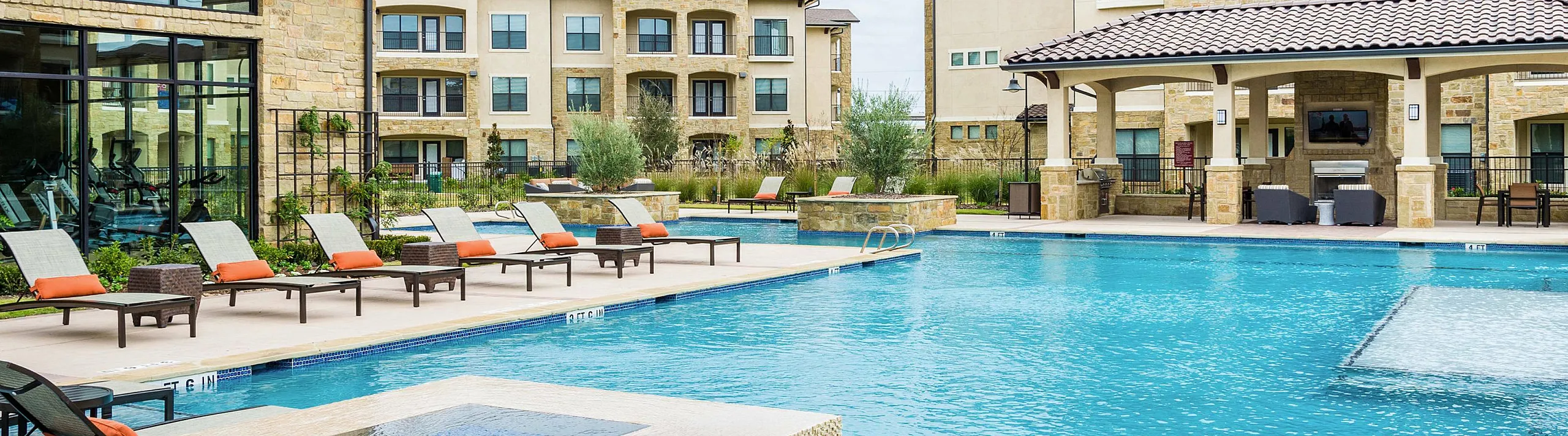 resort style lounge seating beside the sparkling pool