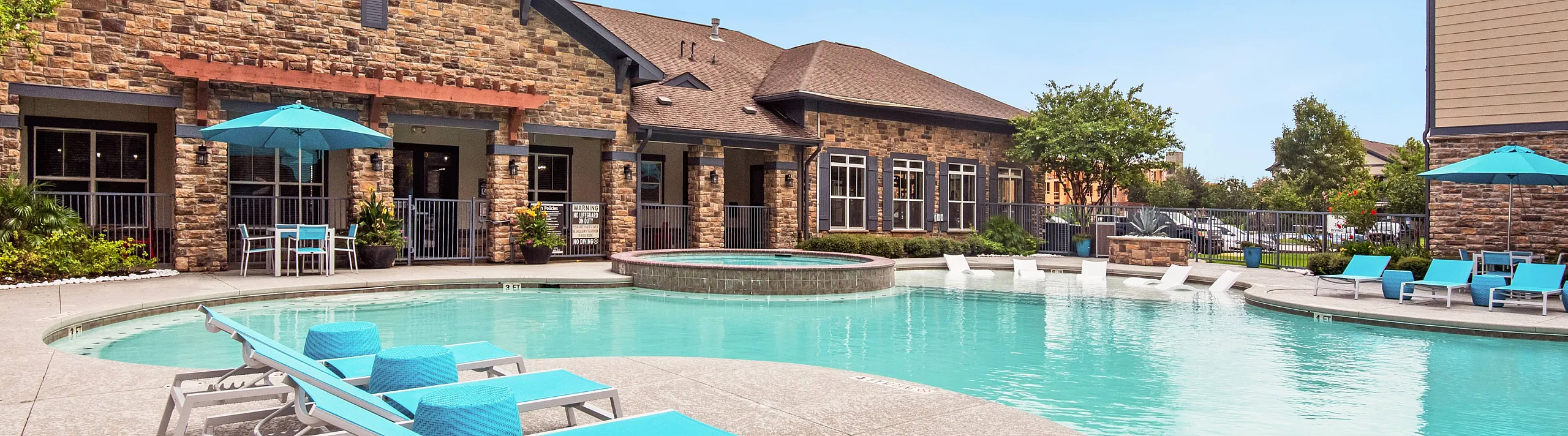 lounge seating beside the clubhouse and pool