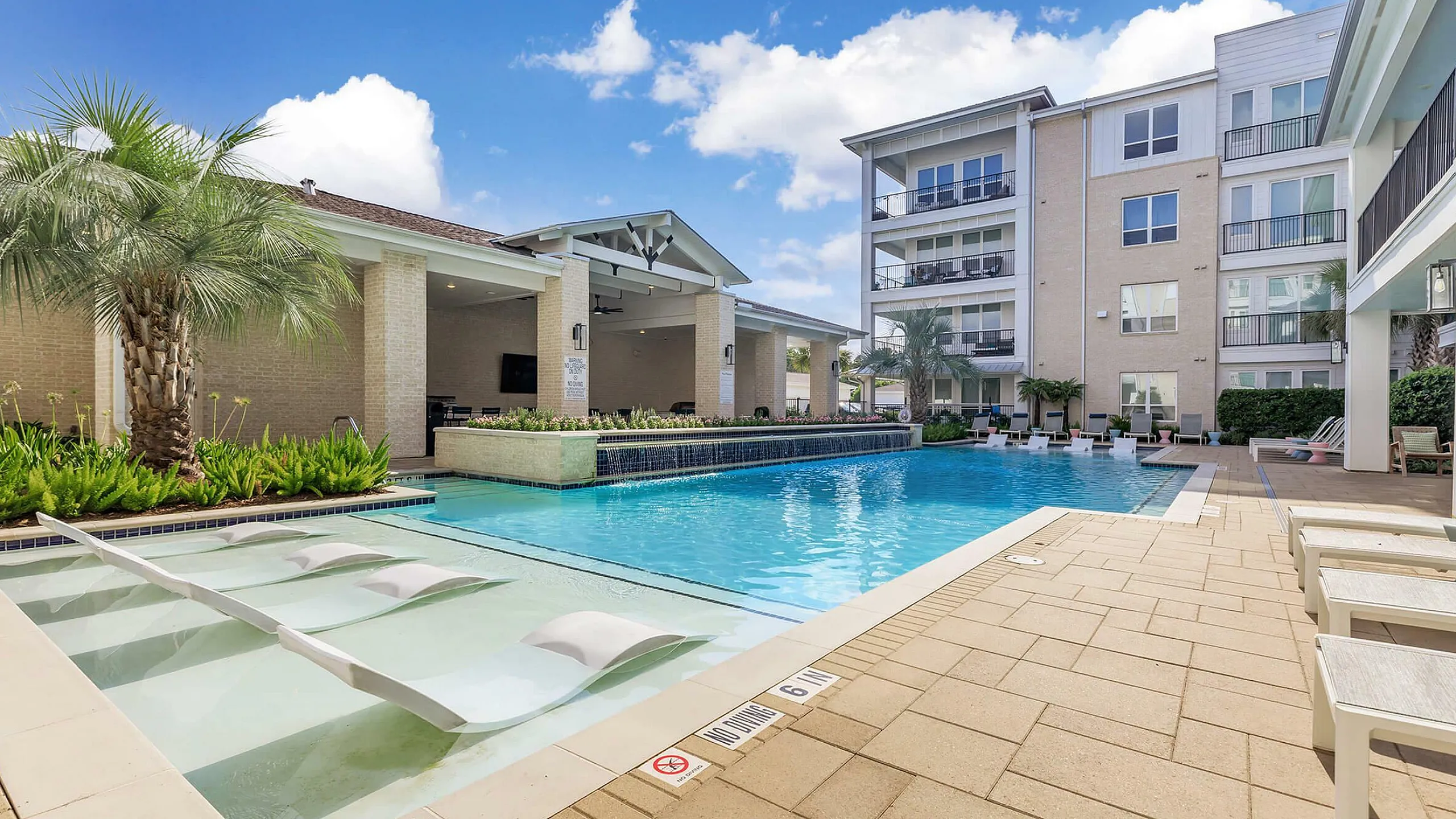 sparkilng pool with resort style lounge seating