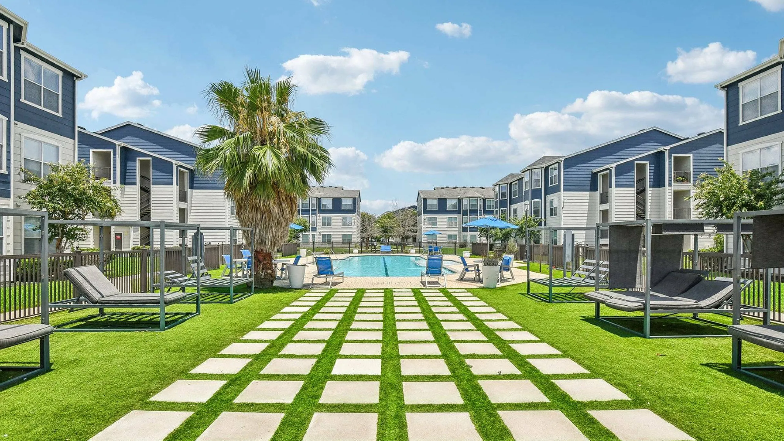 stepping stones leading up to the pool with beautiful landscaping