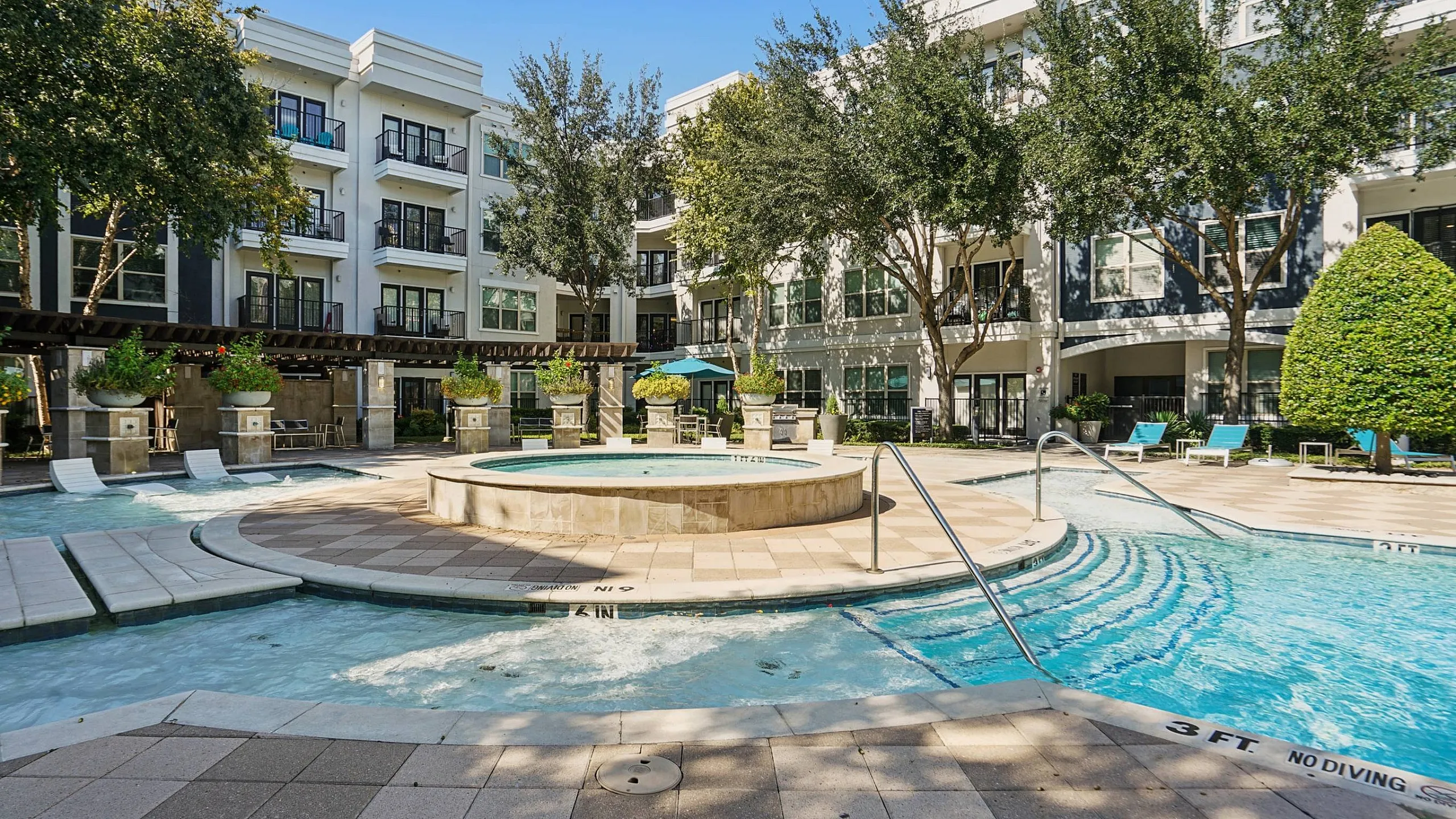 sparkiling pool with resort style lounge seating